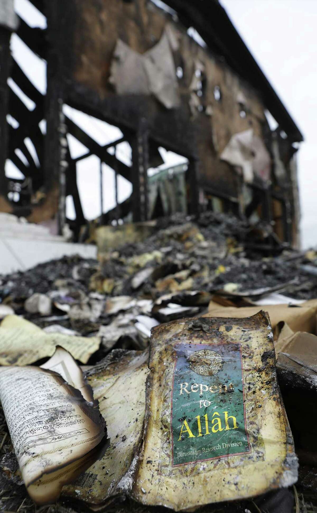 A burned Islamic study book is now debris outside the total loss of the Victoria Islamic Center, in Victoria, Texas on Tuesday, Feb. 2, 2017.