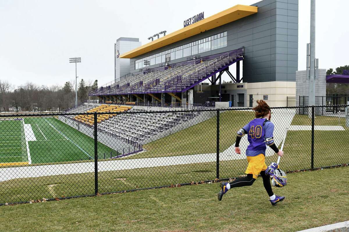 A lacrosse player runs past the football field at University at Albany on Thursday Feb. 2, 2017 in Albany, N.Y. (Lori Van Buren / Times Union) ,
