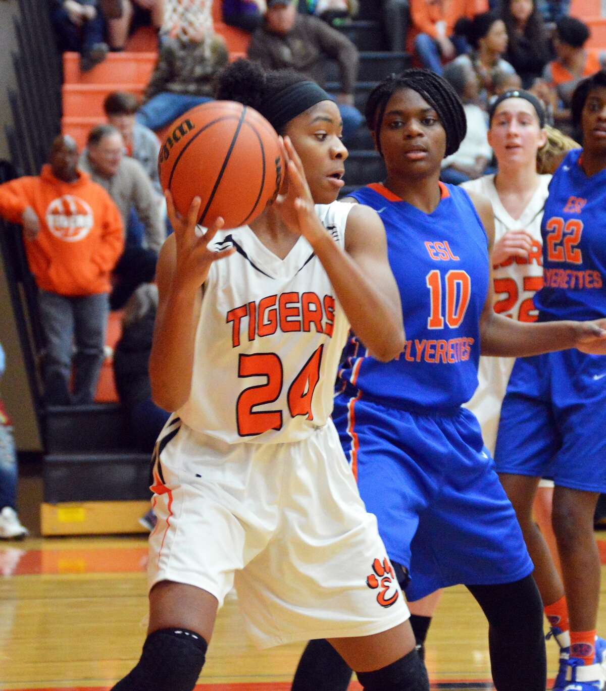 Edwardsville junior Myriah Noodel-Haywood, left, collects a pass underneath the basket during third-quarter action against East St. Louis on Thursday inside Lucco-Jackson Gymnasium.