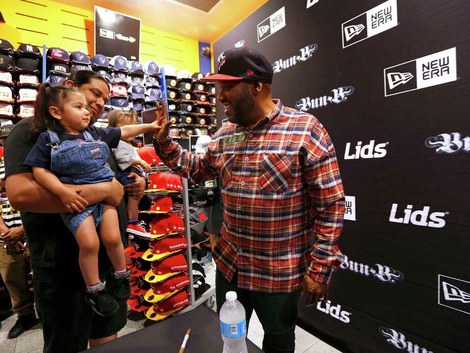 Arya Perez, 2, gives Hip Hop artist and Houston native Bun B a high-five at the Lids store in the Galleria in 2017. &gt;&gt;See more retailers hiring for the holidays... Photo: Annie Mulligan / For The Houston Chronicle / @ 2017 Annie Mulligan & the Houston Chronicle