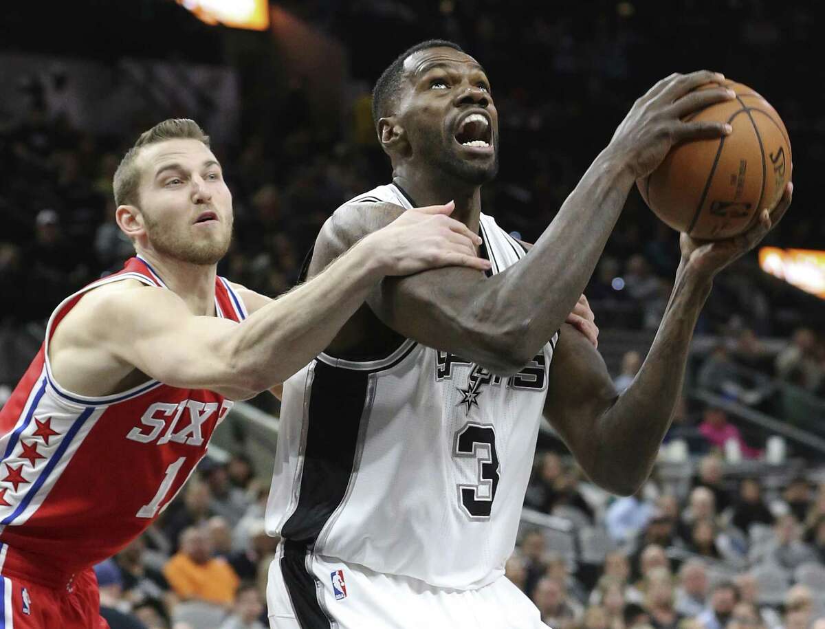 Dwayne Dedman gets held down by Nik Stauskas but makes the layup anyway as the Spurs host the Sixers at the AT&T Center on February 2, 2017.