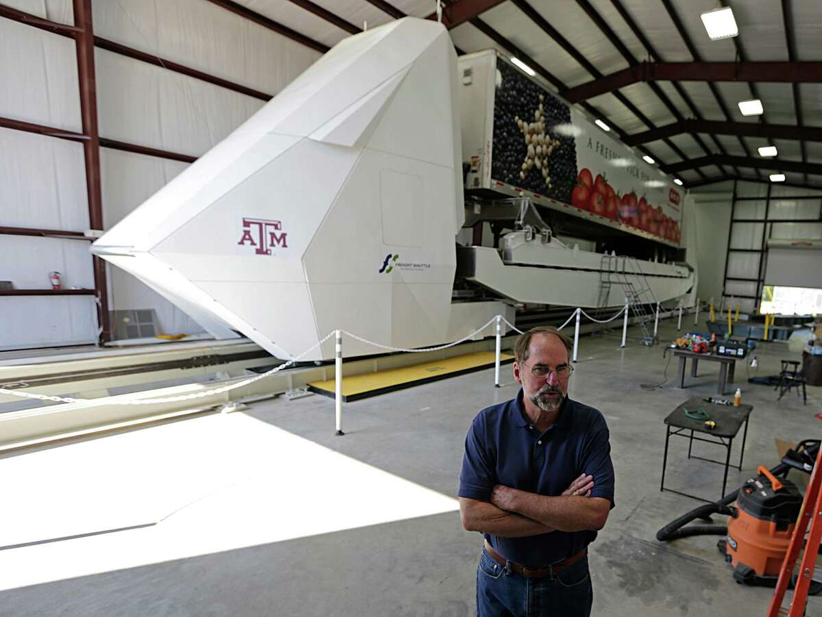 Freight Shuttle International Chairman Stephen Roop stands in front of the shuttle prototype in College Station on Sept. 1, 2016. The shuttle is an electronic shuttle system that pushes cargo containers, which could revolutionize freight transport, and is considered a potential recipient of any additional infrastructure money offered by federal officials.
