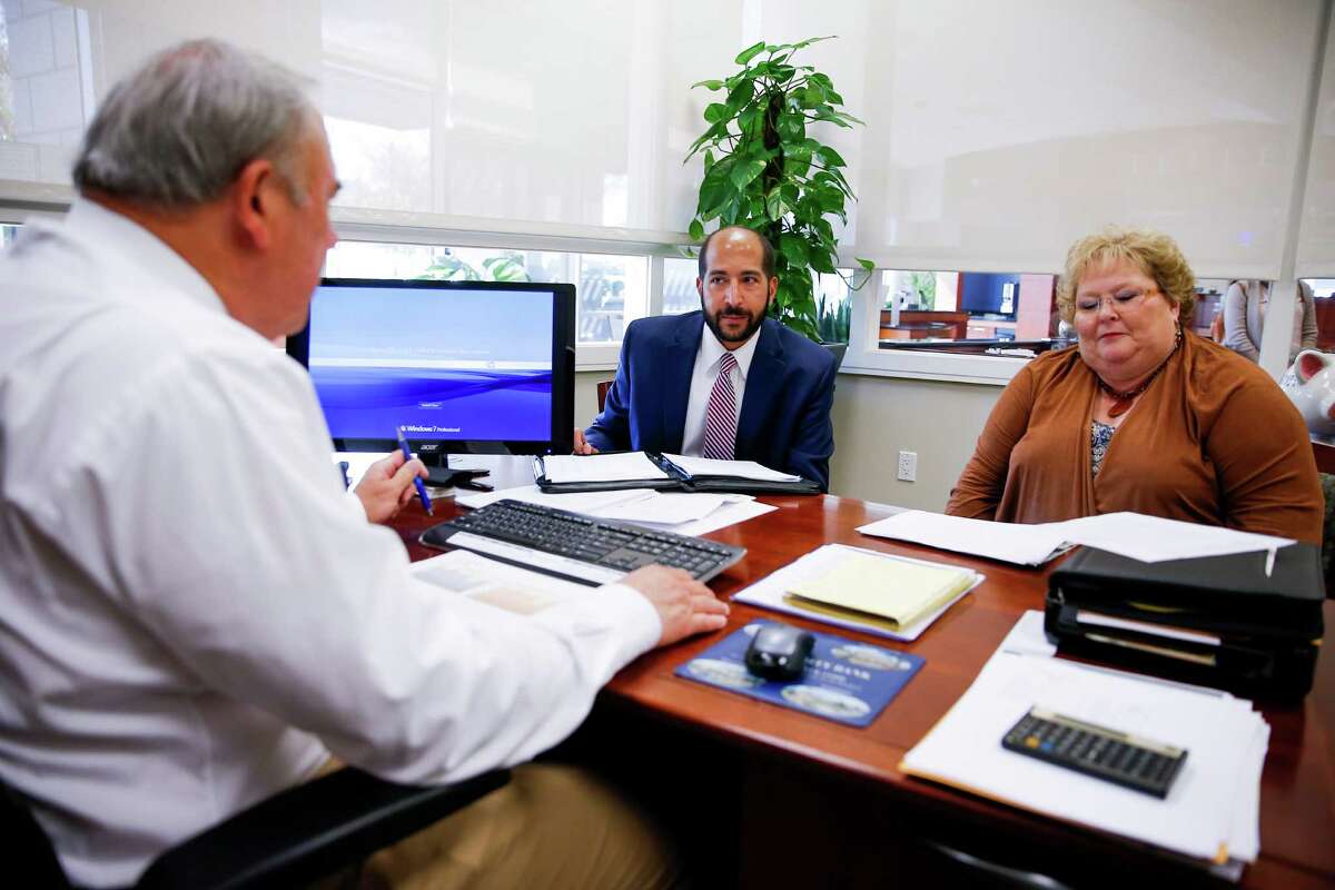 Integrity Bank CEO Charles "Mack" Neff Jr., left, executive vice president Hazem Ahmed, center, and senior vice president director of compliance Debbie Peterson, right, talk during a meeting at their Houston Branch off Washington Avenue Tuesday, Jan. 31, 2017. ( Michael Ciaglo / Houston Chronicle )
