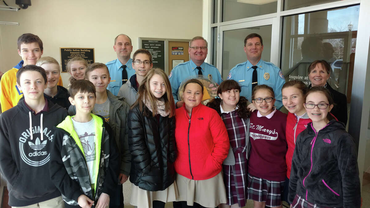 As part of Catholic Schools Week, students at St. Mary's drew pictures, wrote thank you notes and delivered cookies and treats to first responders. Students are pictured here with members of the Edwardsville Police Department.