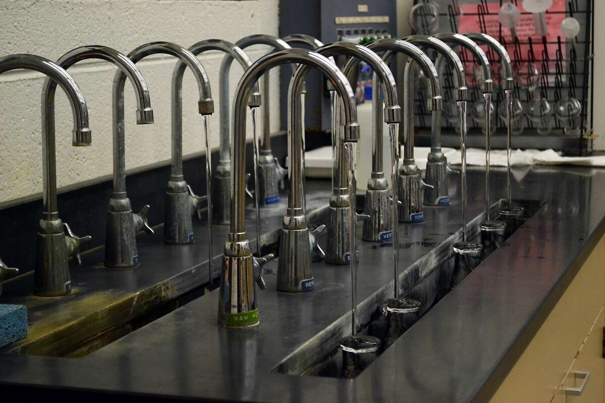 Water at each stage in the plant process fills beakers to be tested in the lab.