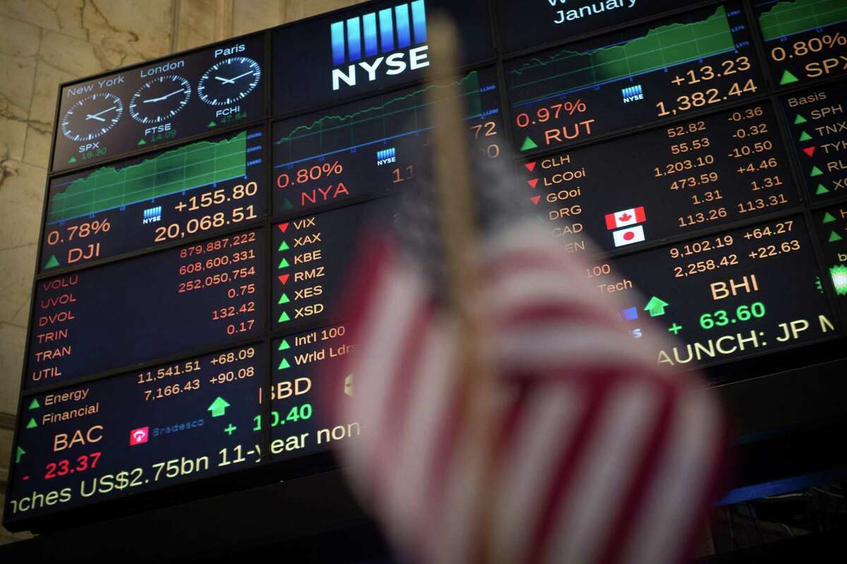 TOPSHOT - A video board shows the Dow Jones closing above 20,000 for the first time at the New York Stock Exchange January 25, 2017 in New York. The Dow Jones Industrial Average finished above 20,000 points for the first time Wednesday, after breaching the milestone at the open, extending a stocks rally that followed US President Donald Trump's election, which sparked hopes of pro-growth policies. / AFP PHOTO / Bryan R. SmithBRYAN R. SMITH/AFP/Getty Images