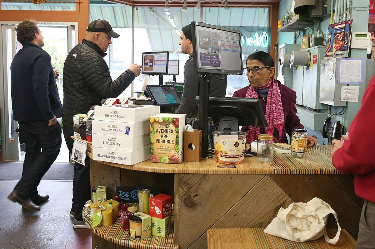 Shanta Nimbark Sacharoff (pink scarf at right) works behind the counter at the Other Avenues co-op in the Sunset on Thursday, February 2, 2017, in San Francisco, Calif.