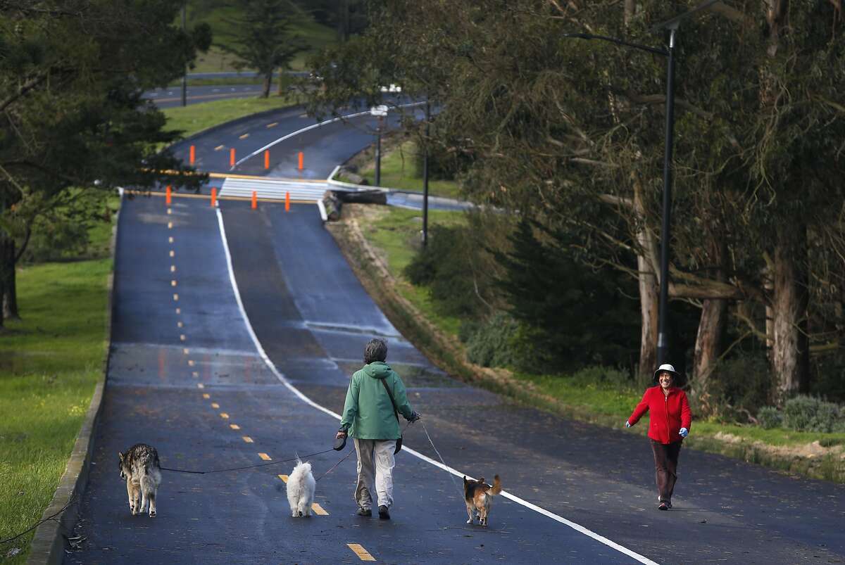 Pedestrians, including Melanie Walker and her dogs, have a dedicated bicycle and pedestrian path all to themselves alongside Mansell Street at McLaren Park in San Francisco, Calif. on Friday, Feb. 3, 2017. The new path officially opens to the public Saturday.