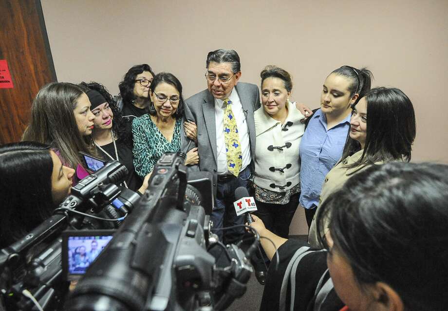 Members of the family stand together as Cameron County Tax Assessor Tony Yzaguirre, center, provides a statement to reporters, Friday, Feb. 3, 2017, in the Nueces County Courthouse in Corpus Christi, Texas. Yzaguirre was acquitted by the jury of all public corruption charges stemming from a 2015 multi-agency investigation and raid on the South Texas county tax office. Yzaguirre, who was elected to another term during the trial, plans to return to work following the weekend. (Jason Hoekema/The Brownsville Herald via AP) Photo: Jason Hoekema, MBR / Associated Press / AP 2017