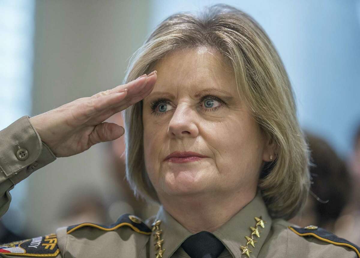 Sheriff Sally Hernandez salutes the American flag during the oath of office ceremony at the Travis County Commissioners court on Jan. 4. Her refusal to honor all detention holds from immigration authorities prompted Gov. Greg Abbott to withhold some state funding.
