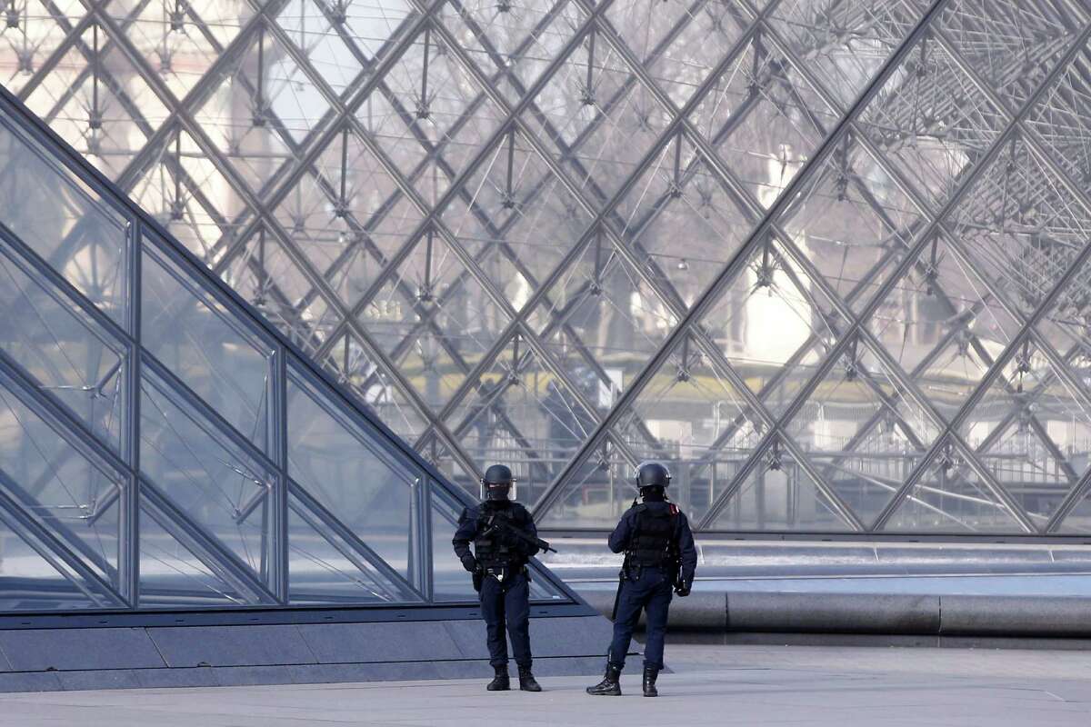 Police officers patrol at the pyramid outside the Louvre museum in Paris,Friday, Feb. 3, 2017. Paris police say a soldier has opened fire outside the Louvre Museum after he was attacked by someone, and the area is being evacuated. (AP Photo/Thibault Camus)