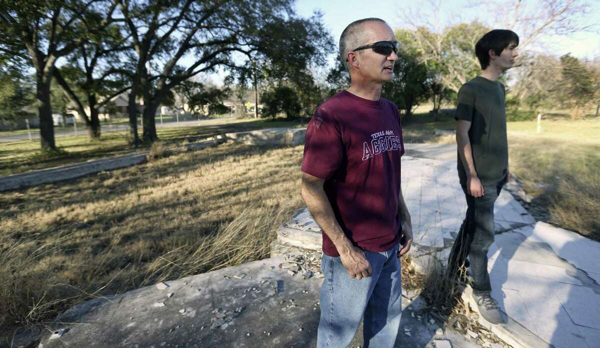 Matthew Hodde stands with this son Feb. 1, 2017 on the foundation of his former El Verde Road home in Leon Valley. Hodde was among those residents of the road who agreed to sell their homes and move in 2010 due to the risk of flooding by Huebner Creek.