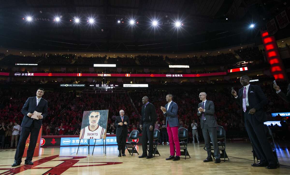 Former Houston Rockets and Hall of Fame center Yao Ming stands as he is honored by the Rockets and, from left, owner, Leslie Alexander, former teammates, Hakeem Olajuwon, Shane Battier, NBA Commissioner Adam Silver, and former teammate Dikembe Mutombo duirng a halftime a halftime ceremony where Yao's number 11 jersey was retired at Toyota Center on Friday, Feb. 3, 2017, in Houston. ( Brett Coomer / Houston Chronicle )