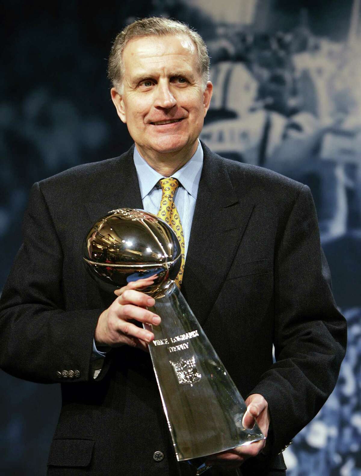 NFL Commissioner Paul Tagliabue holds the Vince Lombardi Trophy after delivering his State of the NFL remarks in Detroit Friday, Feb. 3, 2006. Tagliabue announced in a statement Monday March 20, 2006 that he is retiring as NFL commissioner in July, after more than 16 years on the job (AP Photo/Chuck Burton)