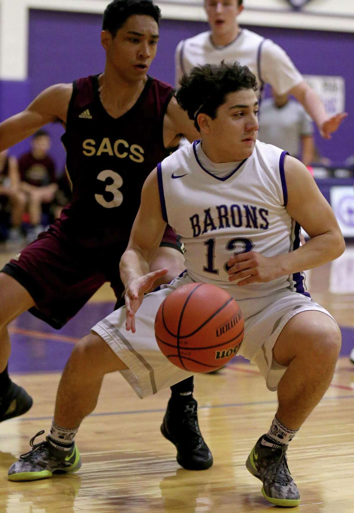 Jesse Llamas of Saint Mary's Hall looks for room around San Antonio Christian's Alex Green during first half action Friday Feb. 3, 2017 at Saint Mary's Hall.