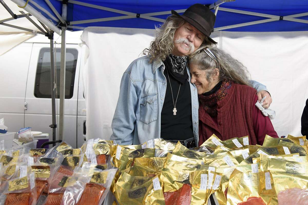 Mike and Sally Hiebert of Cap'n Mike's Holy Smoke Salmon pose for a portrait in their booth at the Ferry Plaza Farmer's Market in San Francisco, CA on Saturday, February 4, 2017.