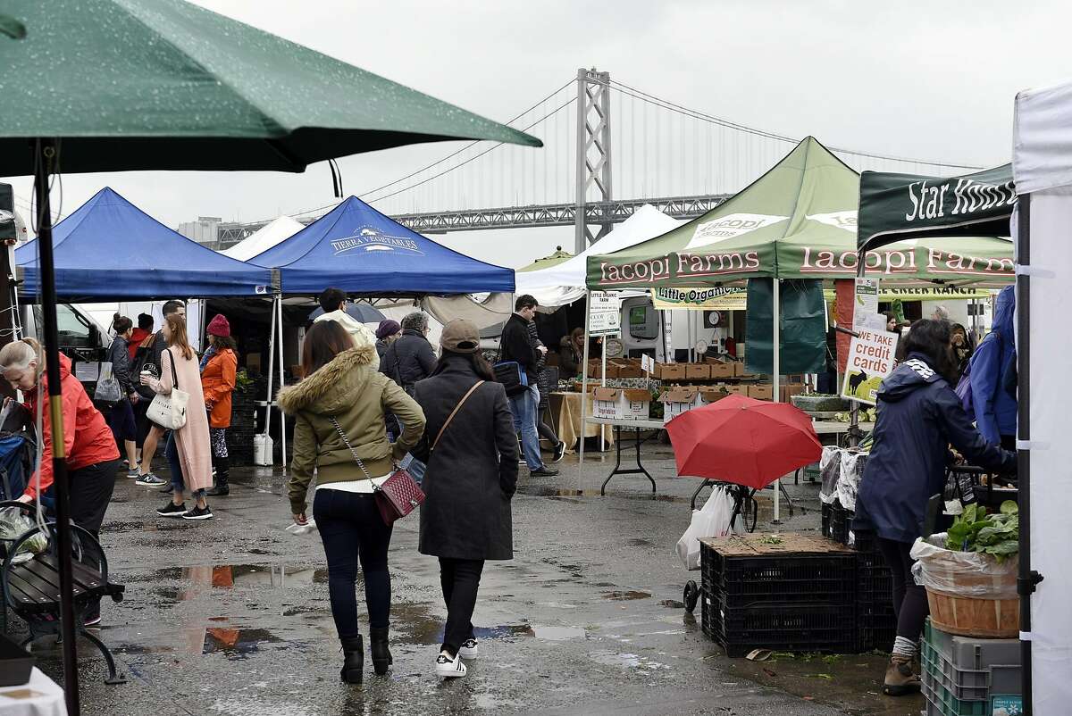 Northern California rains have wreaked havoc on local farms that sell their wares at farmers' markets like the Ferry Plaza, pictured.