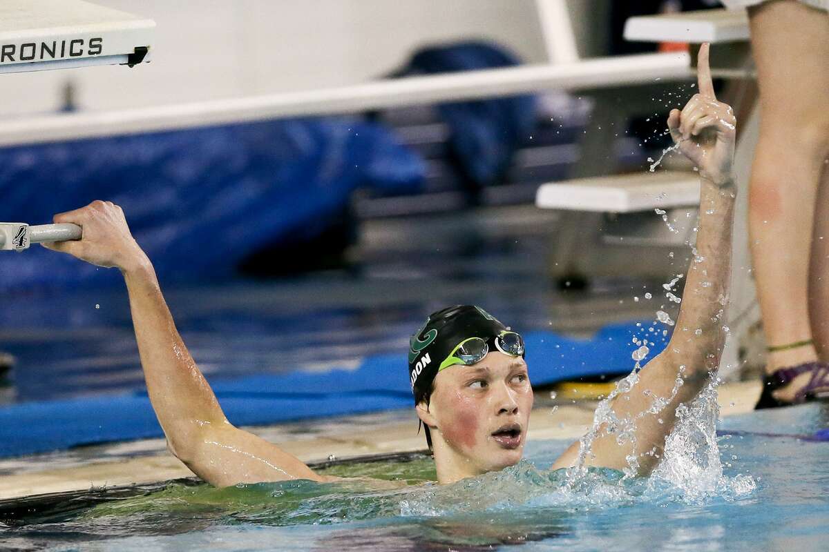 Reagan’s Zach Yeadon celebrates after winning the boys 500-yard freestyle during the Region VII-6A swimming championships at Davis Natatorium on Feb. 4, 2017. Yeadon set a new regional record and a Davis pool record with a time of 4:21.26.