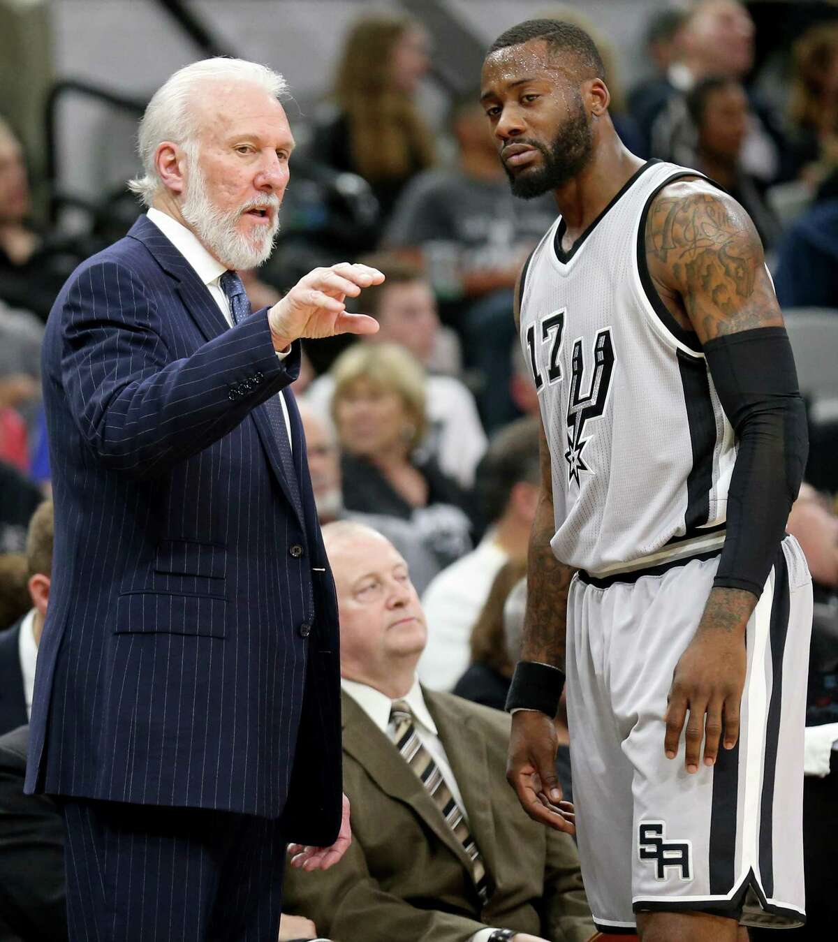 Spurs head coach Gregg Popovich talks with Jonathon Simmons during second half action against the Denver Nuggets on Feb. 4, 2017 at the AT&T Center.