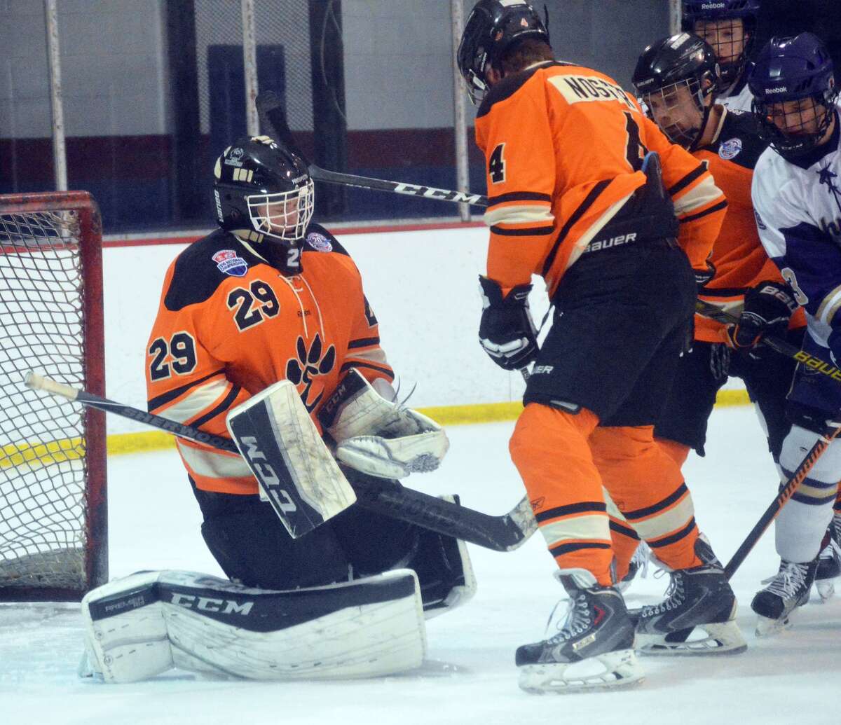 Edwardsville goalie Matt Griffin, left, hangs on to make save with defenseman Jared Nosser shielding him from CBC during the first period in Affton, Mo.