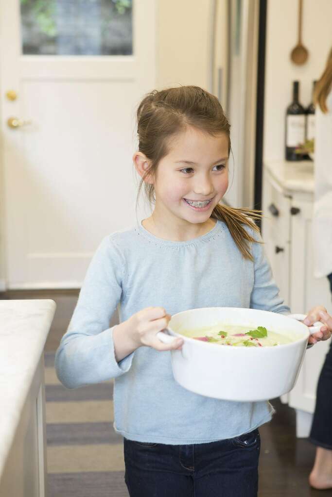 Wiebke Liu's daughter brings out the soup made from one of the mixes that Liu creates from scratch. Photo: Vivian Johnson, Special To The Chronicle