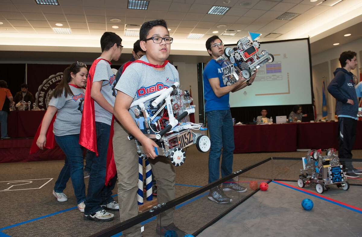 Harmony Science Academy robotics team Digicore's Robert Vega and Alexander High School's robotics team Robert Aranda place their robots in the competition area on Saturday, February 4, 2017 at the TAMIU Student Center during the LISD and UISD Robotics League Championships.