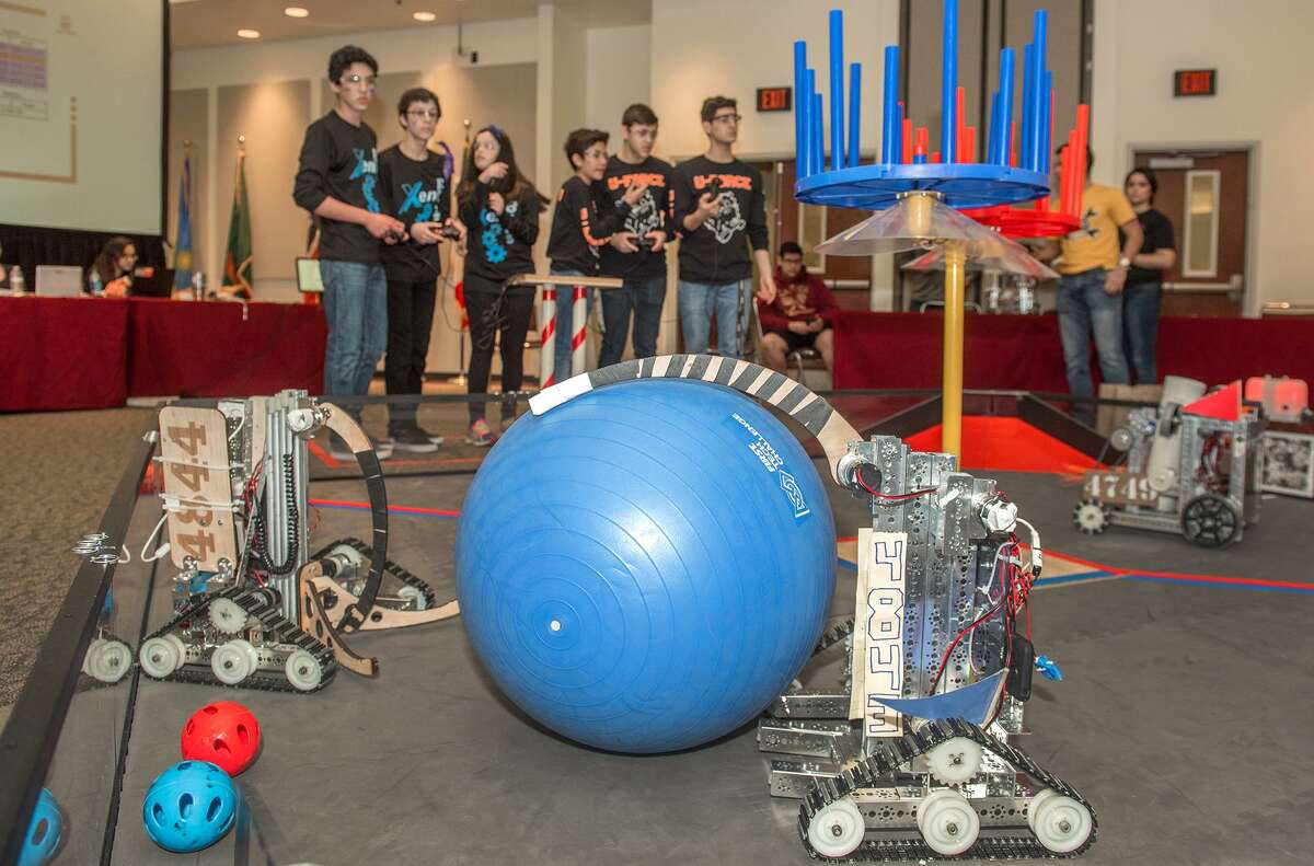 Lyndon B. Johnson Alpha Wolves robotics team's robots are seen in the foreground as the United High School Xeno-bots and U-Force robotics teams control their own set of robots on Saturday, February 4, 2017 at the TAMIU Student Center during the LISD and UISD Robotics League Championships.