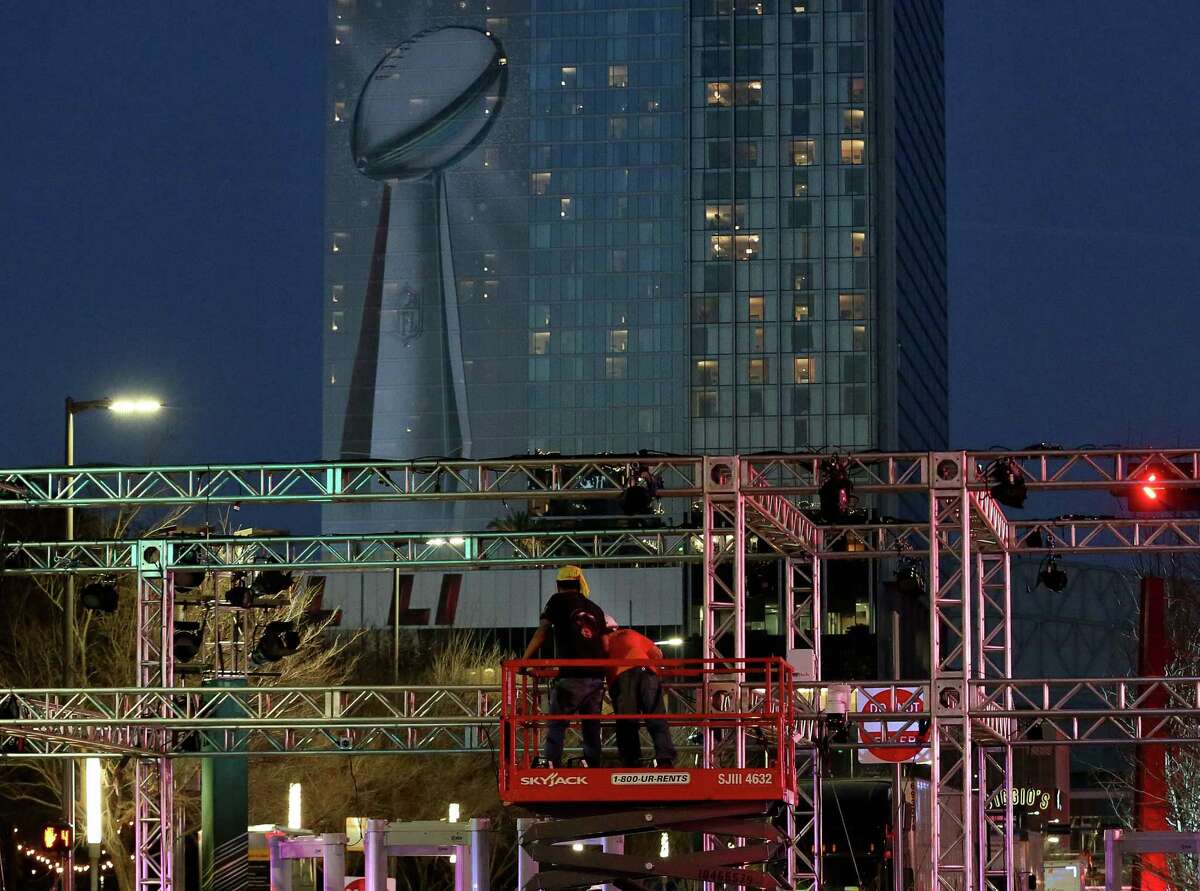 Workers taking down Super Bowl LIVE entrance structures after the area was closed at 3 p.m. Sunday, Feb. 5, 2017, in Houston.