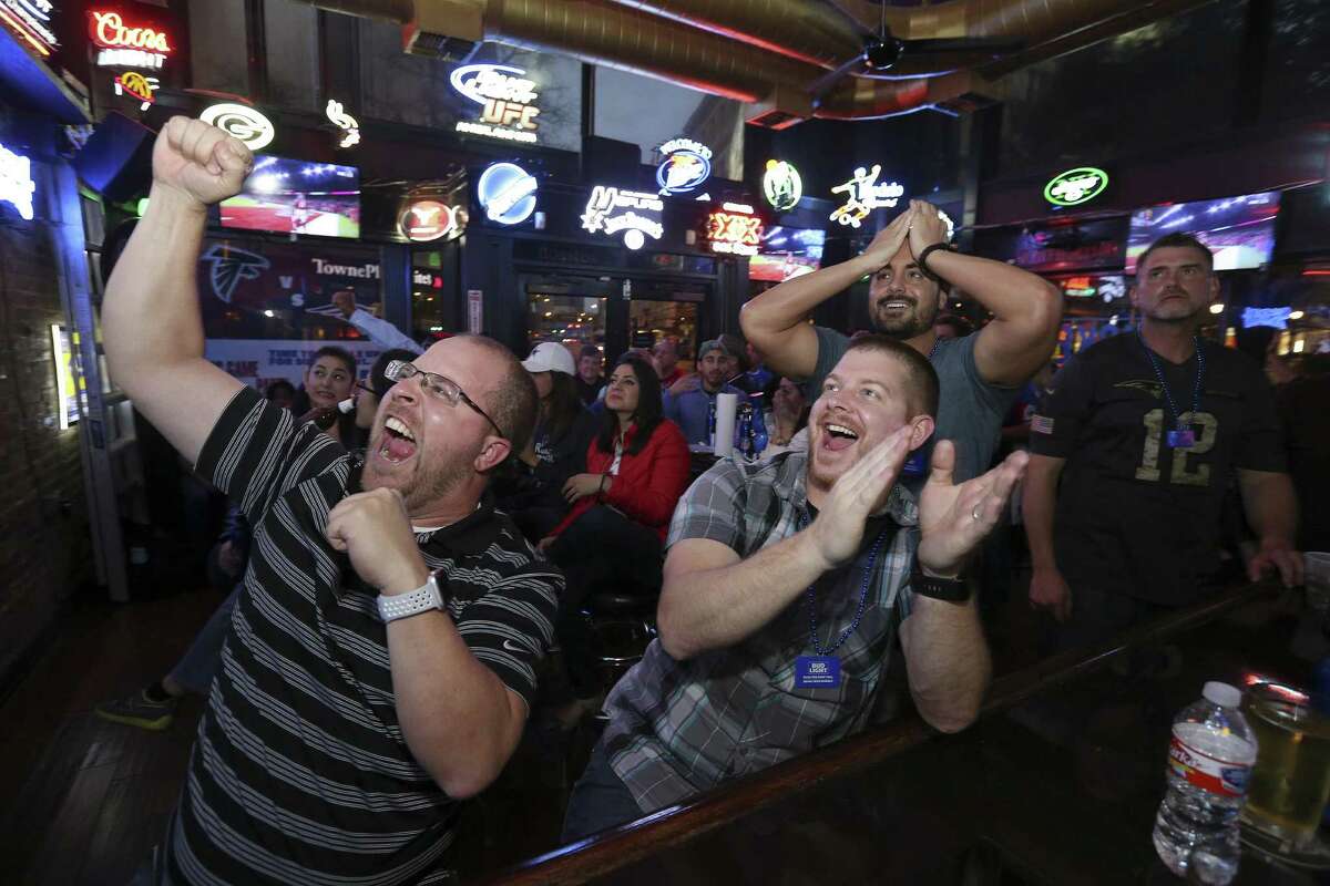 Falcons fans Eric Smith, 40, (from left), Darin Miller, 35 both of Massillon, OH, Patriots fans Jeff Van Buren, 34 of Pittsburgh, PA, and Joe Renzoni, 34 of Worcester, MA, watch the Super Bowl Sunday Feb. 5, 2017 at The Ticket Sports Pub.