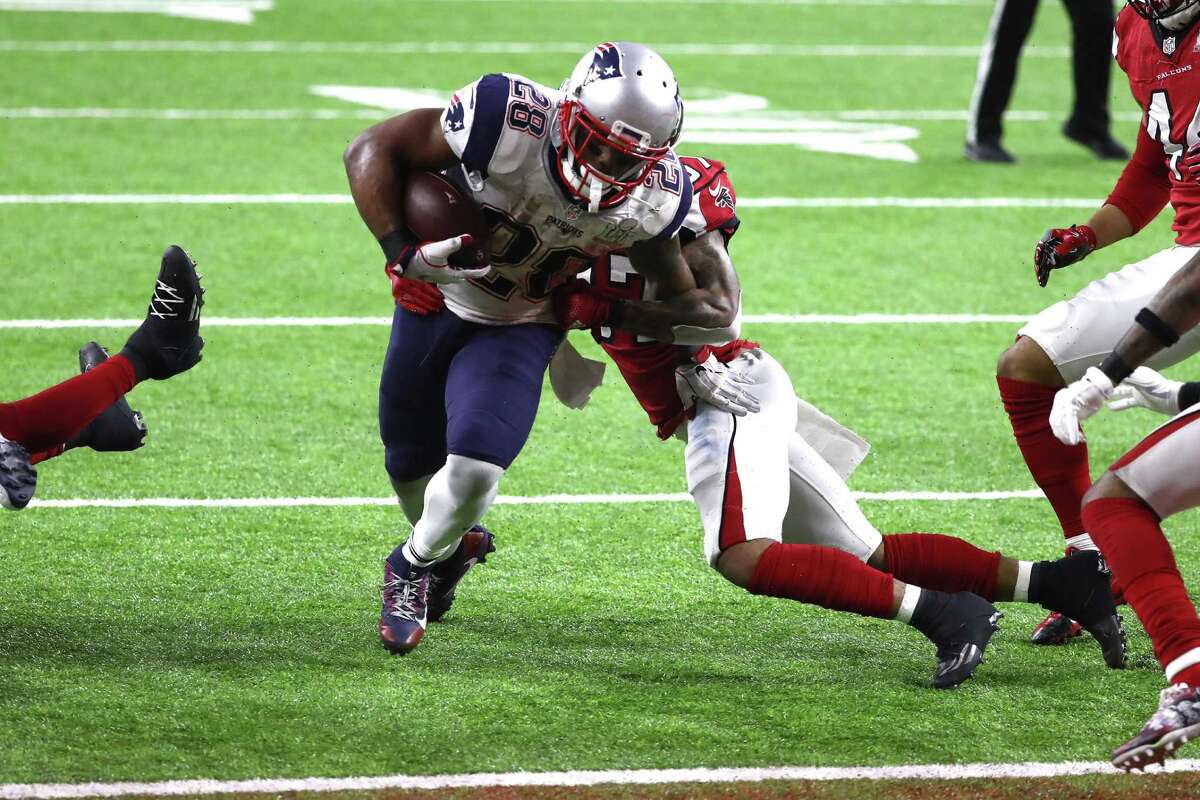 HOUSTON, TX - FEBRUARY 05: James White #28 of the New England Patriots scores the game winning two yard touchdown in overtime against the Atlanta Falcons during Super Bowl 51 at NRG Stadium on February 5, 2017 in Houston, Texas. (Photo by Elsa/Getty Images)
