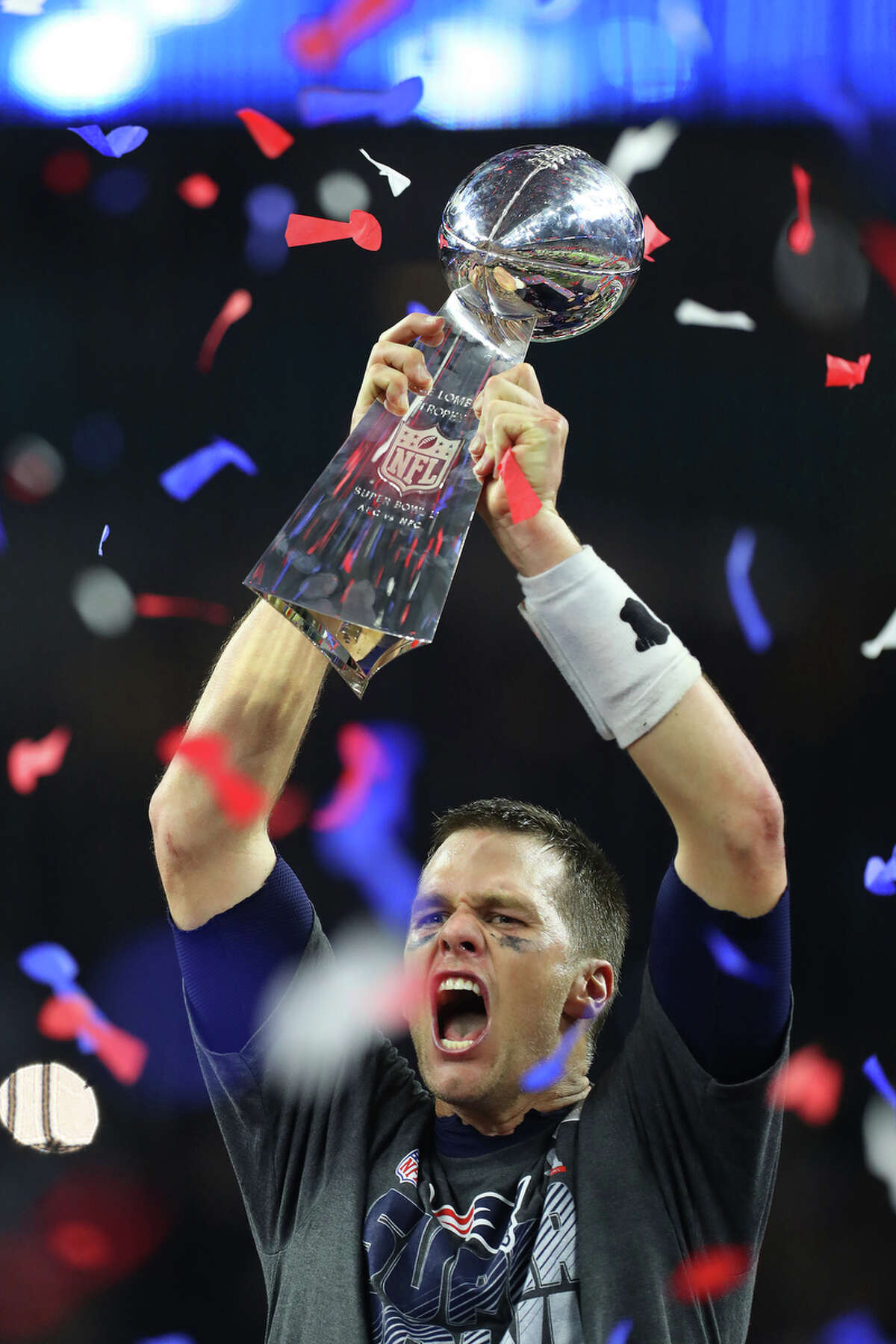 New England Patriots quarterback Tom Brady hoist the Lombadi Trophy in the air after the Patriots defeated the Atlanta Falcons in Super Bowl LI at NRG Stadium on Sunday, Feb. 5, 2017, in Houston. ( Brett Coomer / Houston Chronicle )