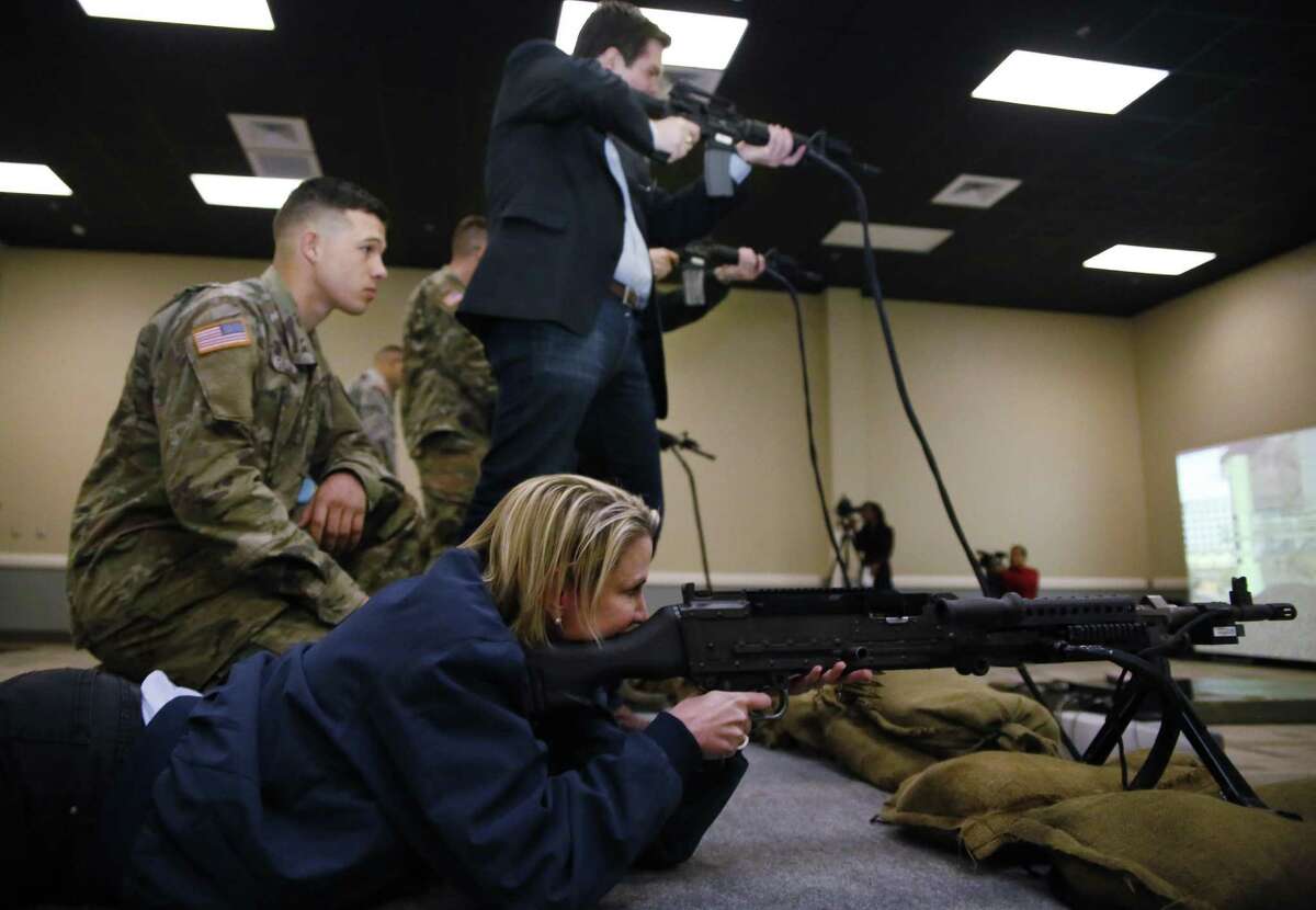 Sen. Dawn Buckingham, District 24, fires a M240G in a simulation during Texas Legislative Day at the military base in Fort Hood, Texas, on Friday, Feb. 3, 2017. State legislators toured the installation and were exposed to various training areas. (Eric J. Shelton/The Killeen Daily Herald via AP)