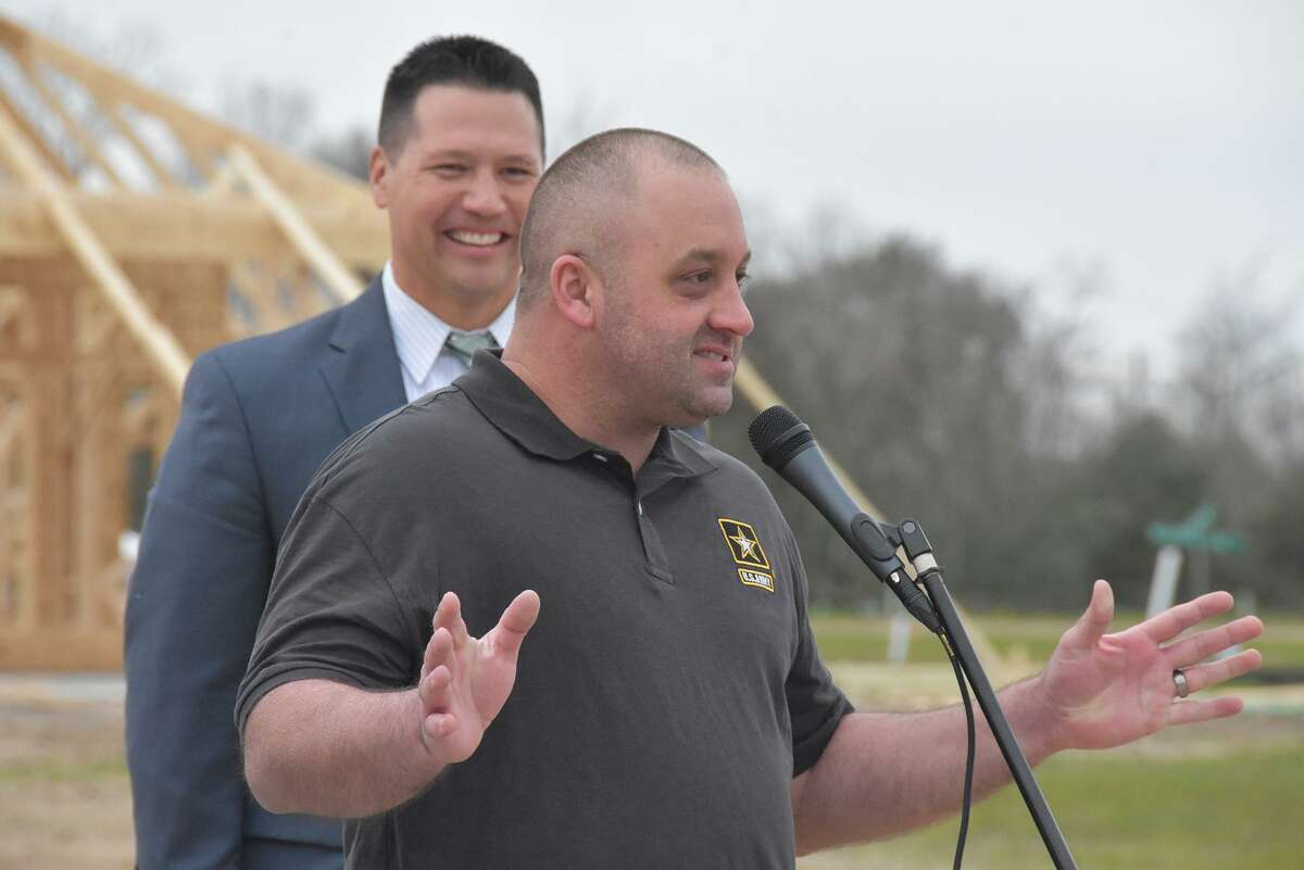 U.S. Army Specialist Cliff Betcher expresses gratitude for his new home at the Jan. 27 Operation Finally Home groundbreaking as Heath Melton, The Howard Hughes Corporation vice president of master planned communities, looks on.