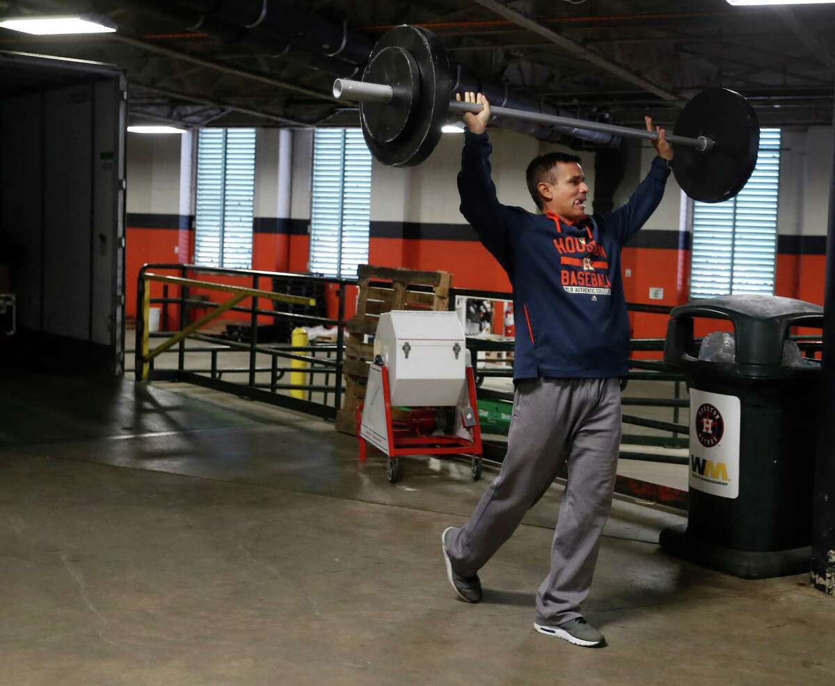 Houston Astros Carlos Munoz carries Orbit's prop weights as the Astros clubhouse staff packed up for spring training in West Palm Beach, at Minute Maid Park Monday, February 6, 2017.