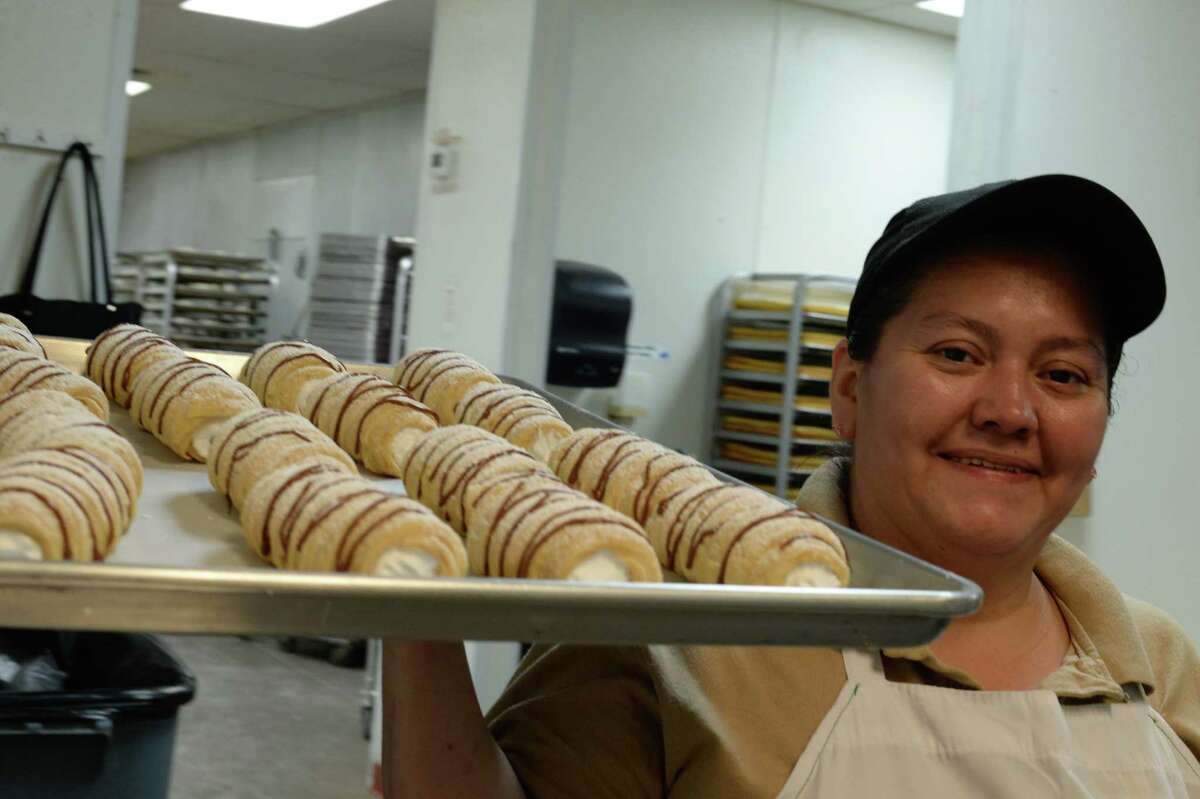 Sandra Guerra takes a tray full of pastries she has prepared to the front at the El Bolillo bakery on Wayside in Houston. El Bolillo plans to open its largest location this spring in Pasadena across the street from the former Pasadena Town Square Mall. The bakery will have an open-concept layout. âWe try to make it an experience," owner Kirk Michaelis says.