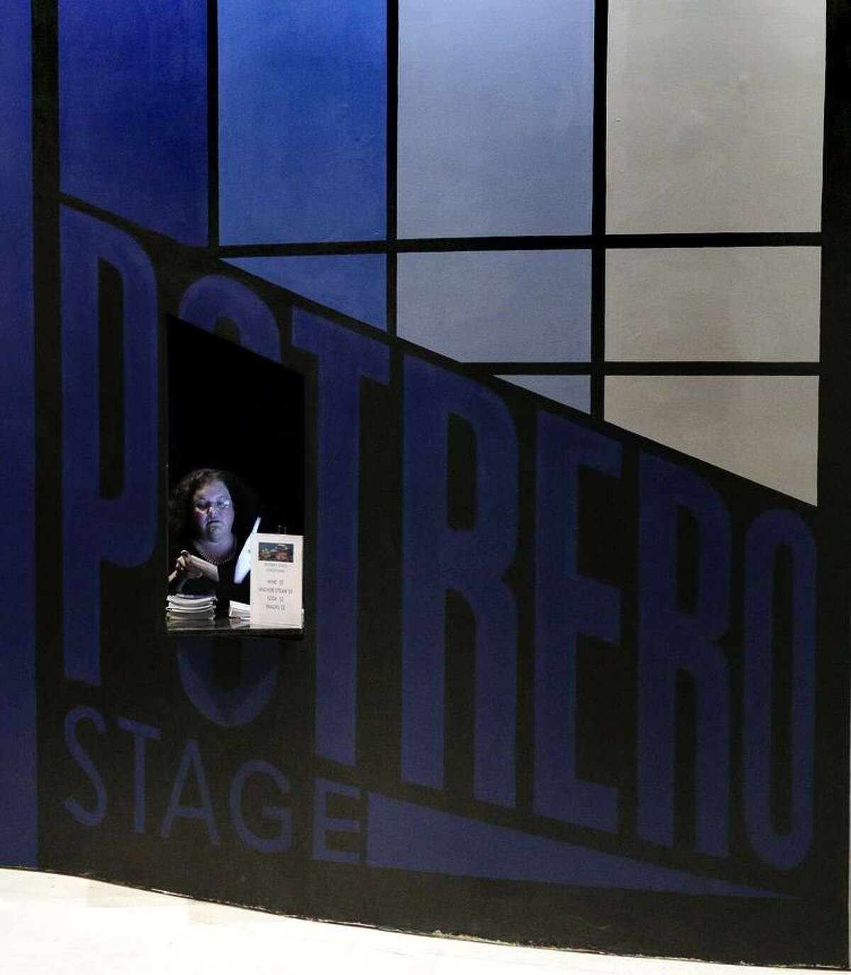 Associate Director Annie Stuart waits in the box office before a preview performance of the Potrero Nuevo Project.