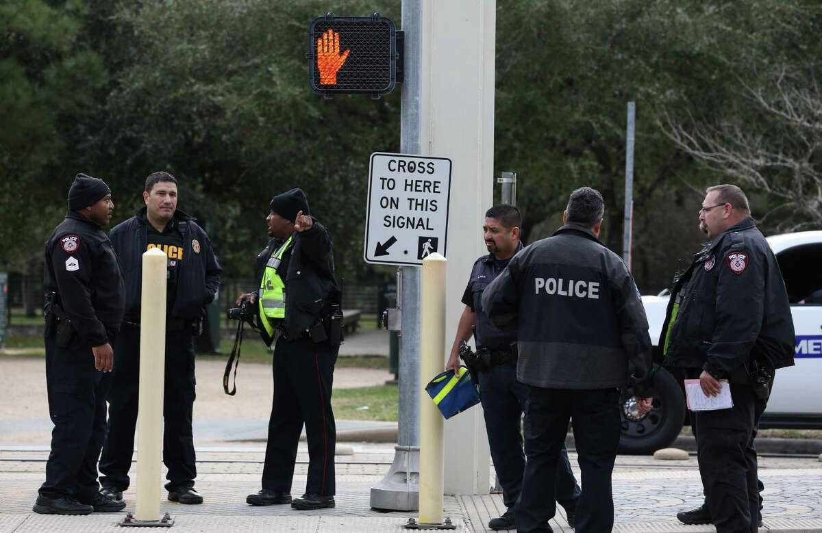 METRO Police Department officers investigate the crosswalk where a METRO Rail train hit and killed a female bicyclist at the crosswalk of Fannin Street and Sunset Boulevard next to Hermann Park on Friday, February 3, in Houston. ( Yi-Chin Lee/ Houston Chronicle)