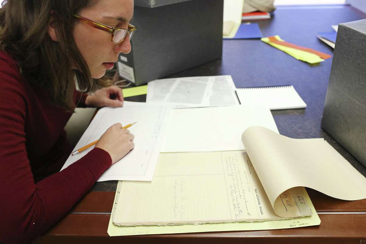 Jessica Nowlin, data research analyst, looks over documents from the Stewart Title records in the University of Texas at San Antonio Special Collections department, Wednesday, Jan. 25, 2017. Students from a graduate history class at the university are gathering data from records of real estate in the downtown area of San Antonio. It will be used to create a geographic information systems map for the city?•s tricentennial celebration. The project if funded by Bexar County.