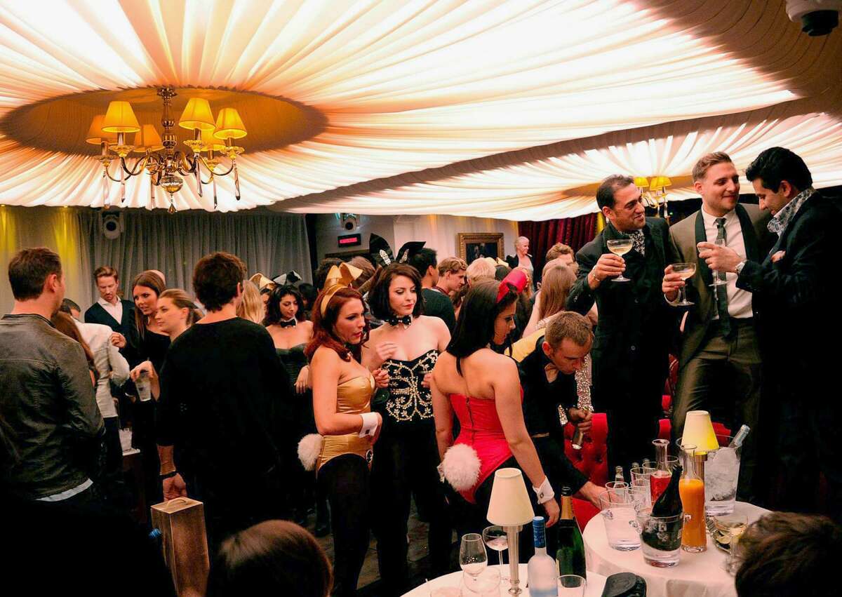 Playboy Bunnies and guests mingle in London's club, which opened in 2011 following a 30-year hiatus. The tightly corseted Playboy Bunnies, with rabbit tails and ears, will soon be back in business in New York City.
