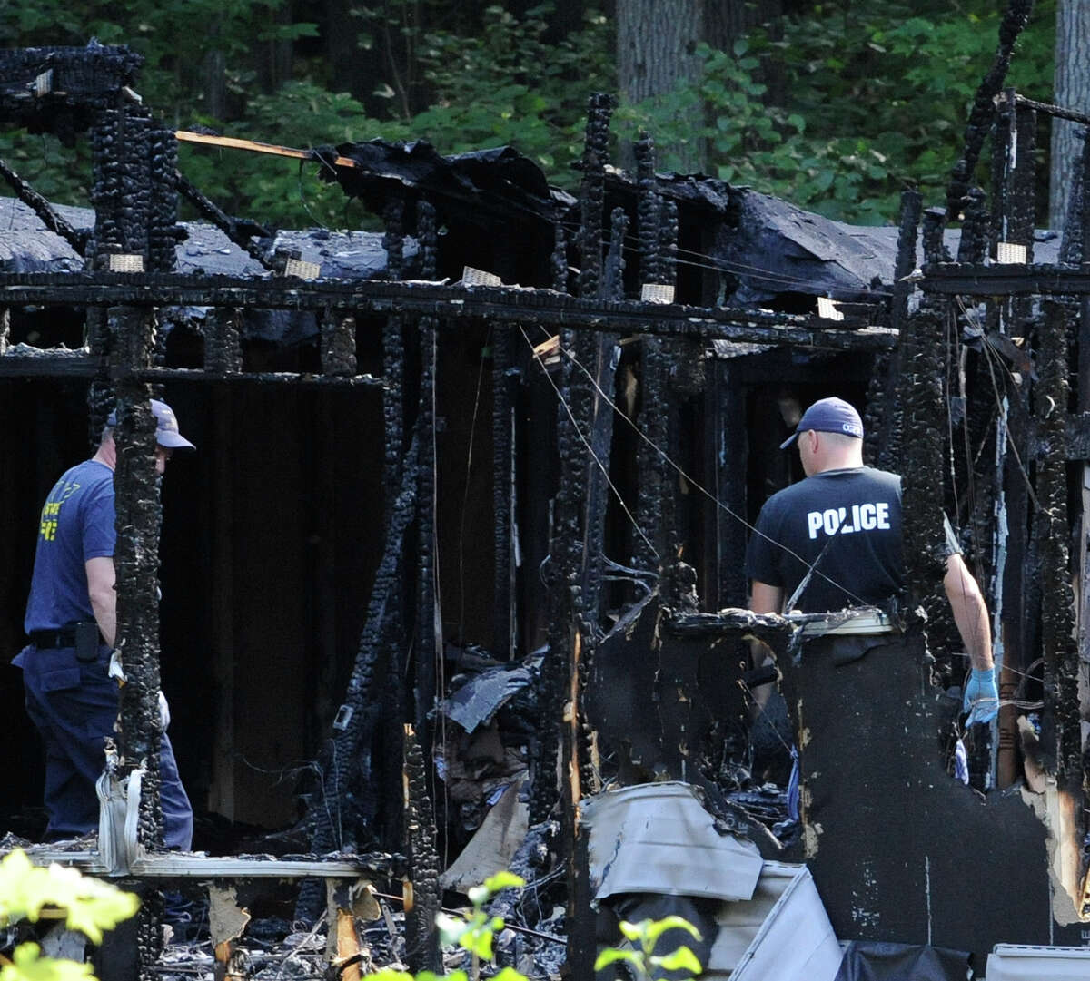 New York State Fire Investigators assist Washington County authorities in sifting through the debris Thursday morning July 14, 2011 at 118 Turnpike Road in White Creek, N.Y. to determine the cause of a fire that has been labeled suspicious and may have contributed to the lose of three lives at that location. (Skip Dickstein / Times Union)
