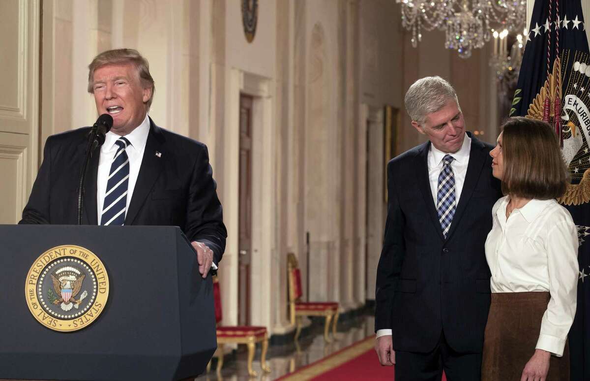 President Donald Trump introduces Judge Neil Gorsuch as his nominee to fill the vacancy on the Supreme Court, in the White House on Jan. 31. On the right is Gorsuch's wife, Louise.