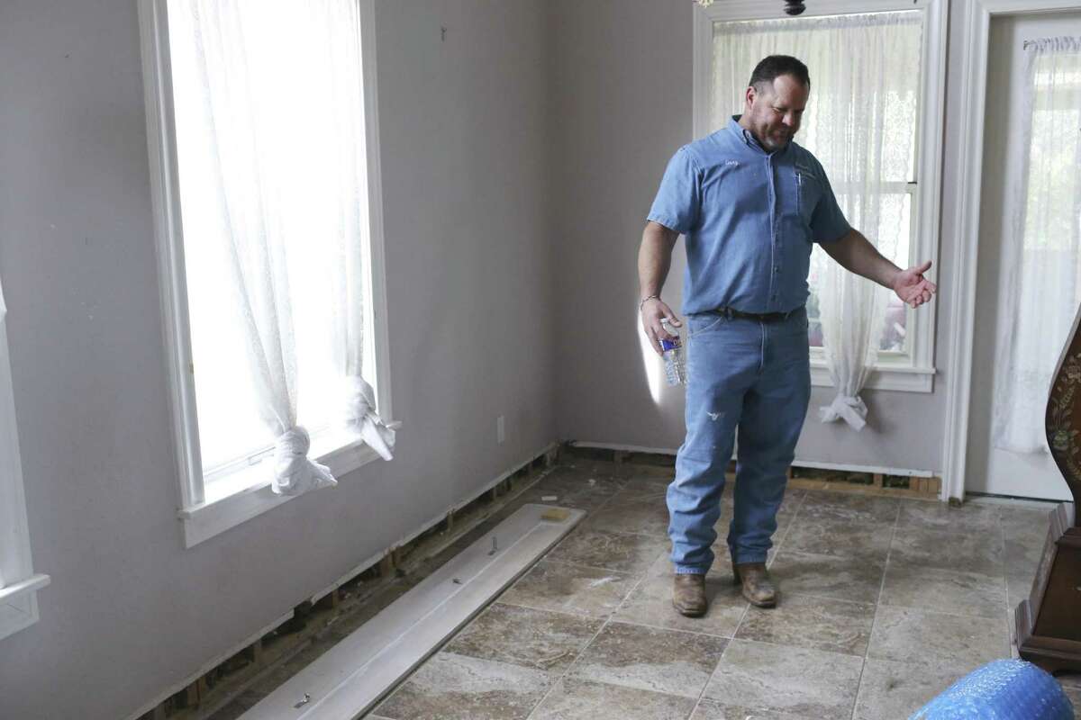 Contractor Gary Schraer checks out the work need done on the home of Lavoin Keith Allison off Boerne Stage Road in North Central Bexar County on Feb. 7, 2017. Almost three weeks ago, a water main broke, flooding the home with up to five inches of water. Schraer has been helping Allison repair and clean up the damage since homeowner’s insurance won't cover the damage. The San Antonio Water System, which owns the water main along Boerne Stage Road in north Bexar County, have said it will only pay the roughly $50,000 bill for drying out the house with industrial blowers, plus $2,500. In an email, SAWS cited "governmental immunity" as a reason it is not liable.