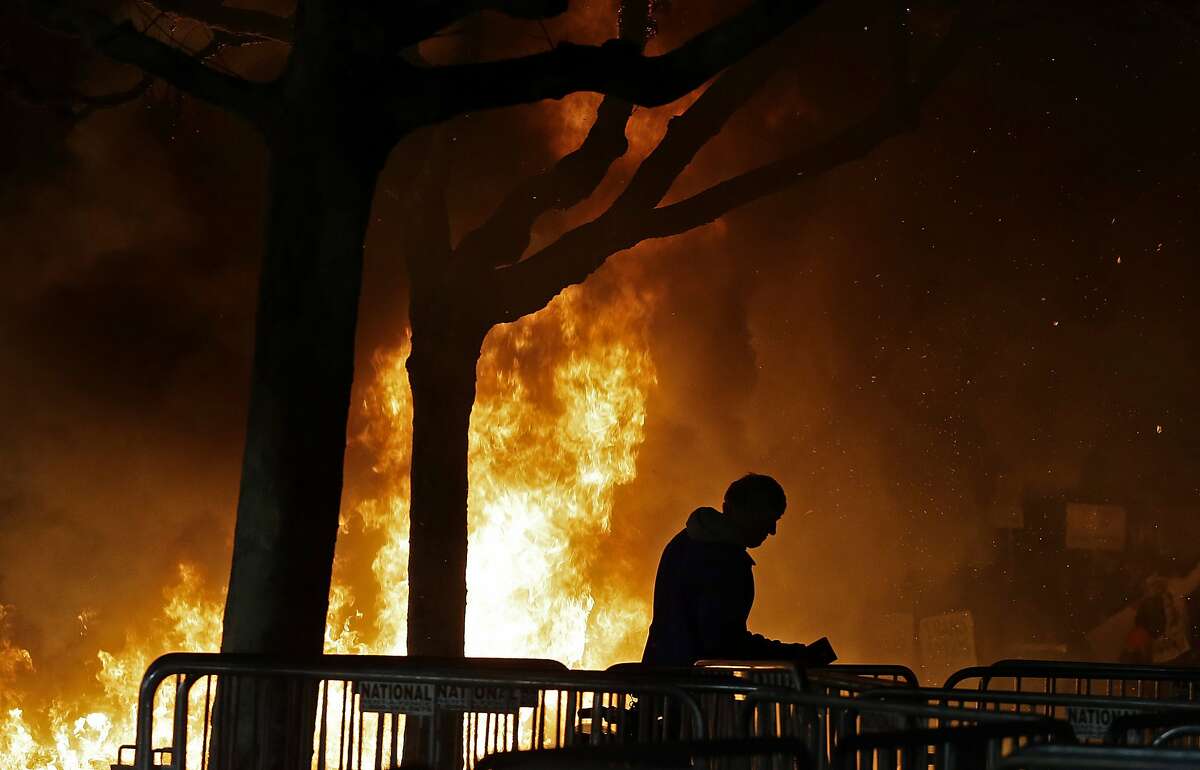 In this Feb. 1, 2017 file photo, a fire set by demonstrators protesting a scheduled speaking appearance by Breitbart News editor Milo Yiannopoulos burns on Sproul Plaza on the University of California, Berkeley campus. UC Berkeley police took a hands-off approach to protesters on the campus last week when violent rioters overtook a largely peaceful protest against a controversial speaker. But that response is being questioned as demonstrators become increasingly hostile and politics are more polarized. (AP Photo/Ben Margot, File)