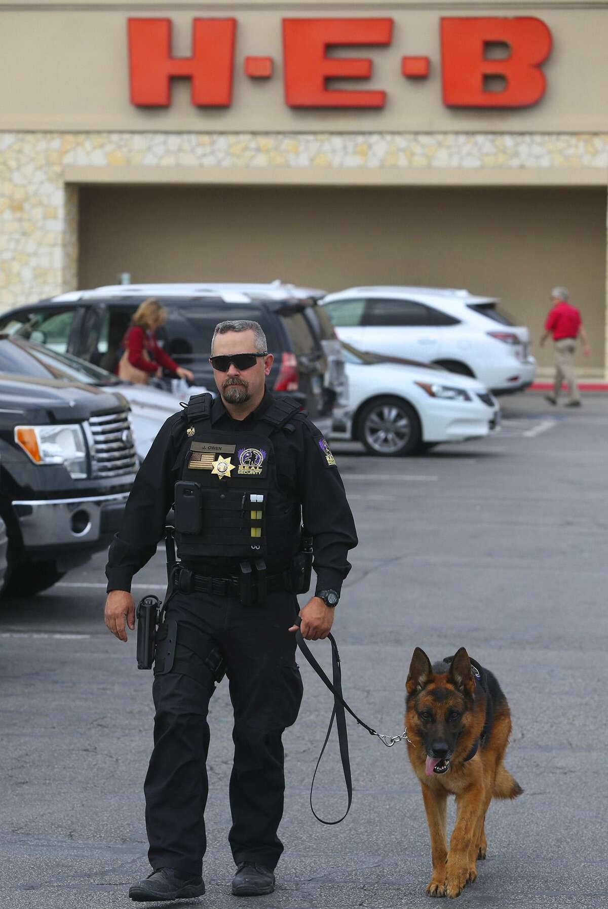 Security officer Justin Owen patrols Monday February 6, 2017 at the H-E-B Lincoln Heights store with a S.E.A.L. Security canine officer "Fak" (right). H-E-B is bringing canine security officers to seven stores in the San Antonio area as part of a partnership with Houston-based S.E.A.L. Security Solutions.