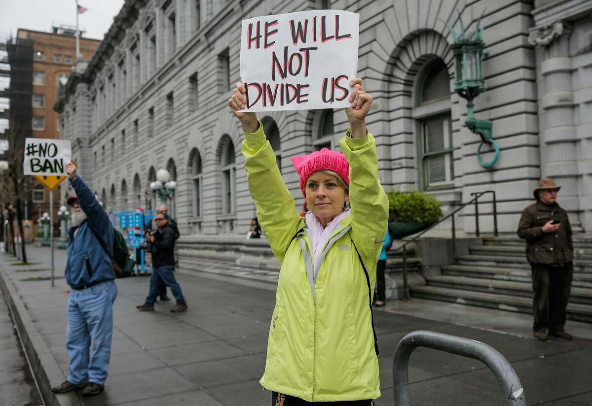 Chrissy Pearce (center) and her father David Pearce, who are both from Napa, demonstrate in front of the Ninth Circuit Court of Appeals which is hearing the travel ban case today in San Francisco, California, on Tuesday, Feb. 7, 2017.