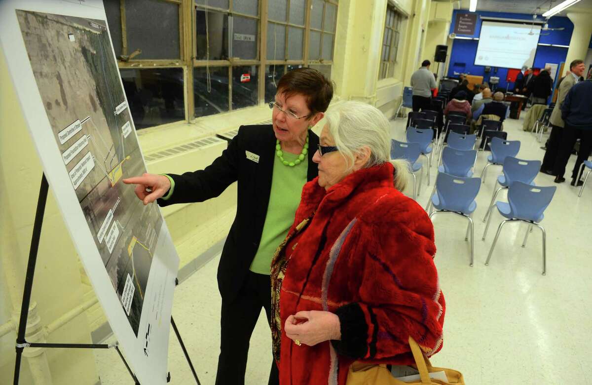Lisa Standley, with VHB Consultants, explains some of the proposed plans for a future train station to City Commissioner Anne Papas Phillips before the start of the Barnum Station Environmental Impact Evaluation public hearing held at the Great Oaks Charter School on Barnum Avenue in Bridgeport on Tuesday night. Feb. 7, 2017. If all goes according to plan, a new train station on the East End of Bridgeport will open in 2021. Barnum Station, which is expected to cost $300 million to build, would spur economic development and help provide jobs.