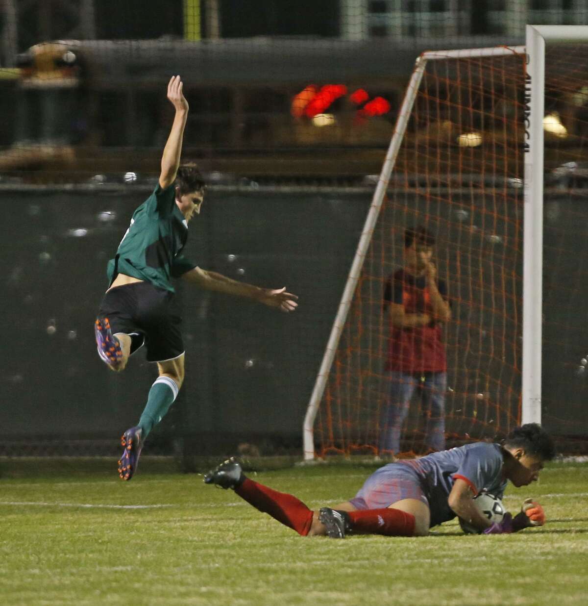 ReaganÕs Shane Malone tries to score over Lee goalie Abisal Ortiz in the District 26-6A boys soccer game between Reagan and Lee on Tuesday, February 7, 2017 at Blossom Soccer Stadium-West