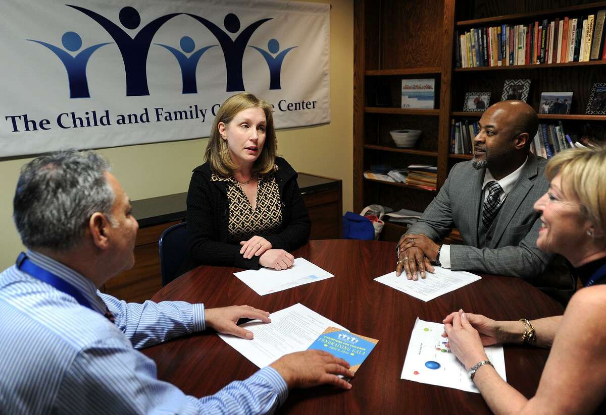 Ann McCarthy, second from left, meets with her co-workers from left; Michael Patota, Terril Pile, and Irma Camacho at The Child & Family Guidance Center at 180 Fairfield Avenue in Bridgeport, Conn. on Wednesday, February 8, 2017. The center is a behavioral health outpatient facility for children and families and works with many undocumented city residents. McCarthy, a Fairfield resident photographed for the Connecticut Post at Monday's sanctuary city rally at Bridgeport City Hall, was used as an example by Mayor Joseph Ganim that suburban residents shouldn't involve themselves in city business.