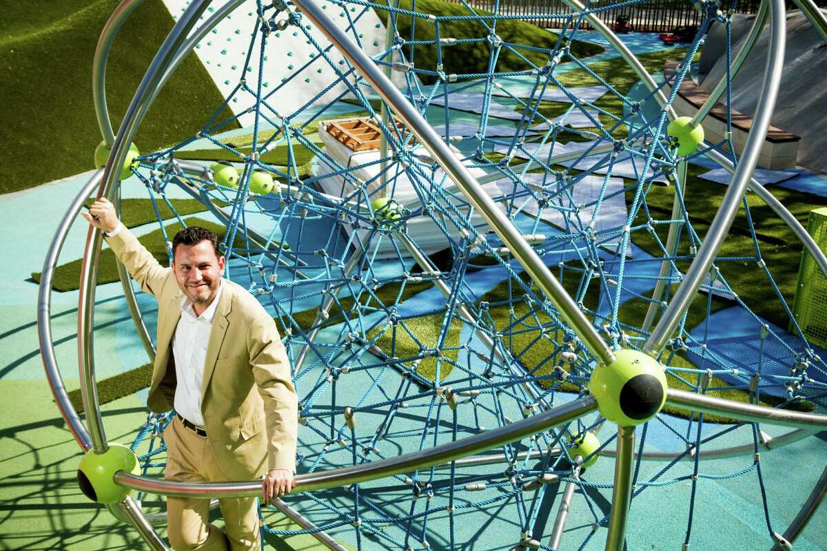 Levy Park director Doug Overman poses for a portrait in the "Cosmo," a buckyball inspired climbing attraction in the children's play area.