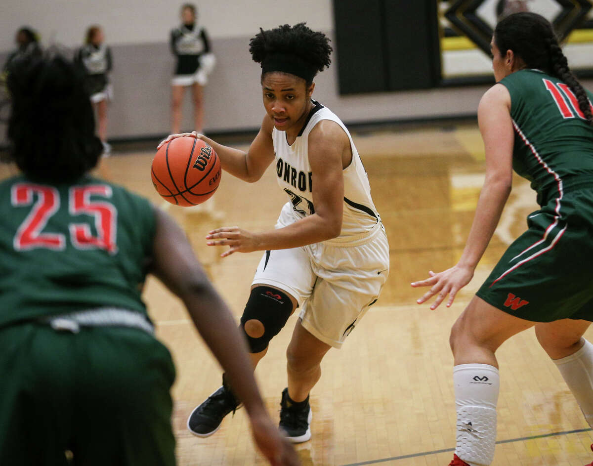 ConroeÂ?’s Alexia Mason (21) tries to get past The Woodlands defenders during the varsity girls basketball game on Tuesday, Feb. 7, 2017, at Conroe High School. (Michael Minasi / Chronicle)